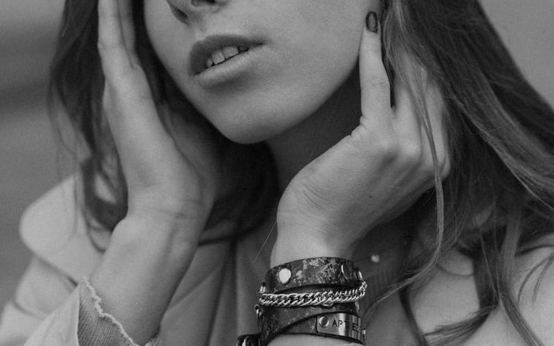 A person is in the middle of a focused yoga sequence in a bright studio.